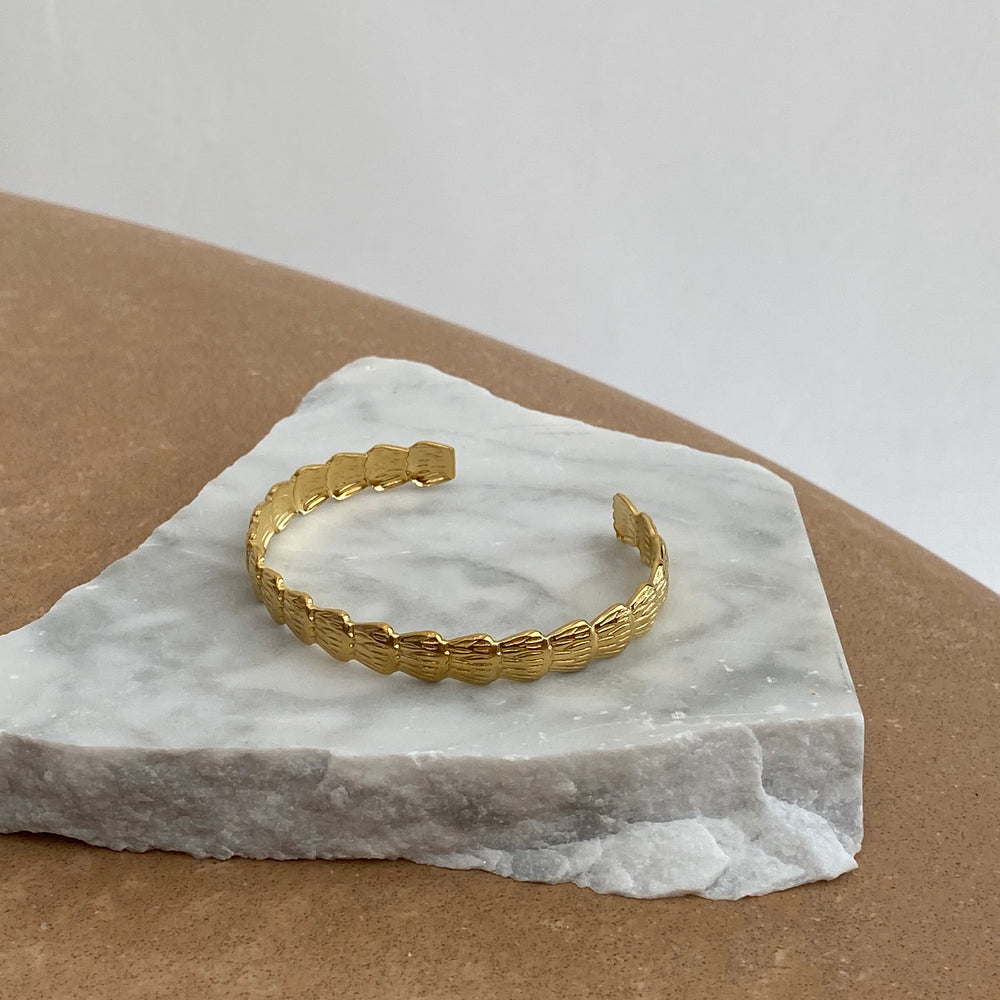 
                      
                        We Are Emte - Scallop Cuff in Gold
                      
                    